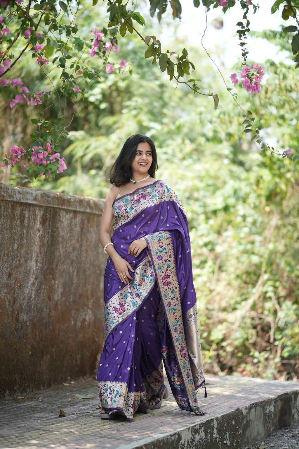 Royal purple Paithani saree with elegant zari buttas and a rich floral border