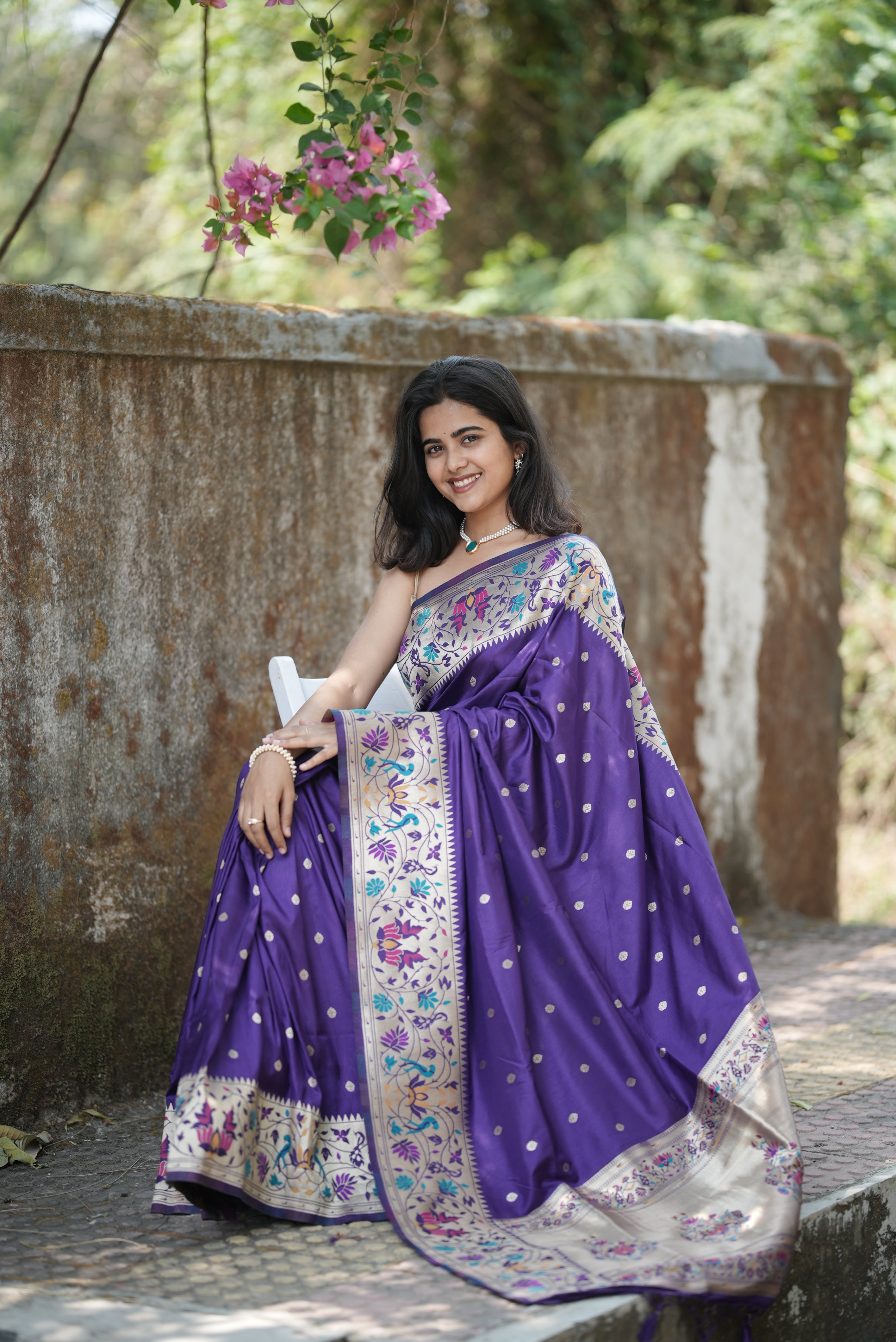 Royal purple Paithani saree with elegant zari buttas and a rich floral border