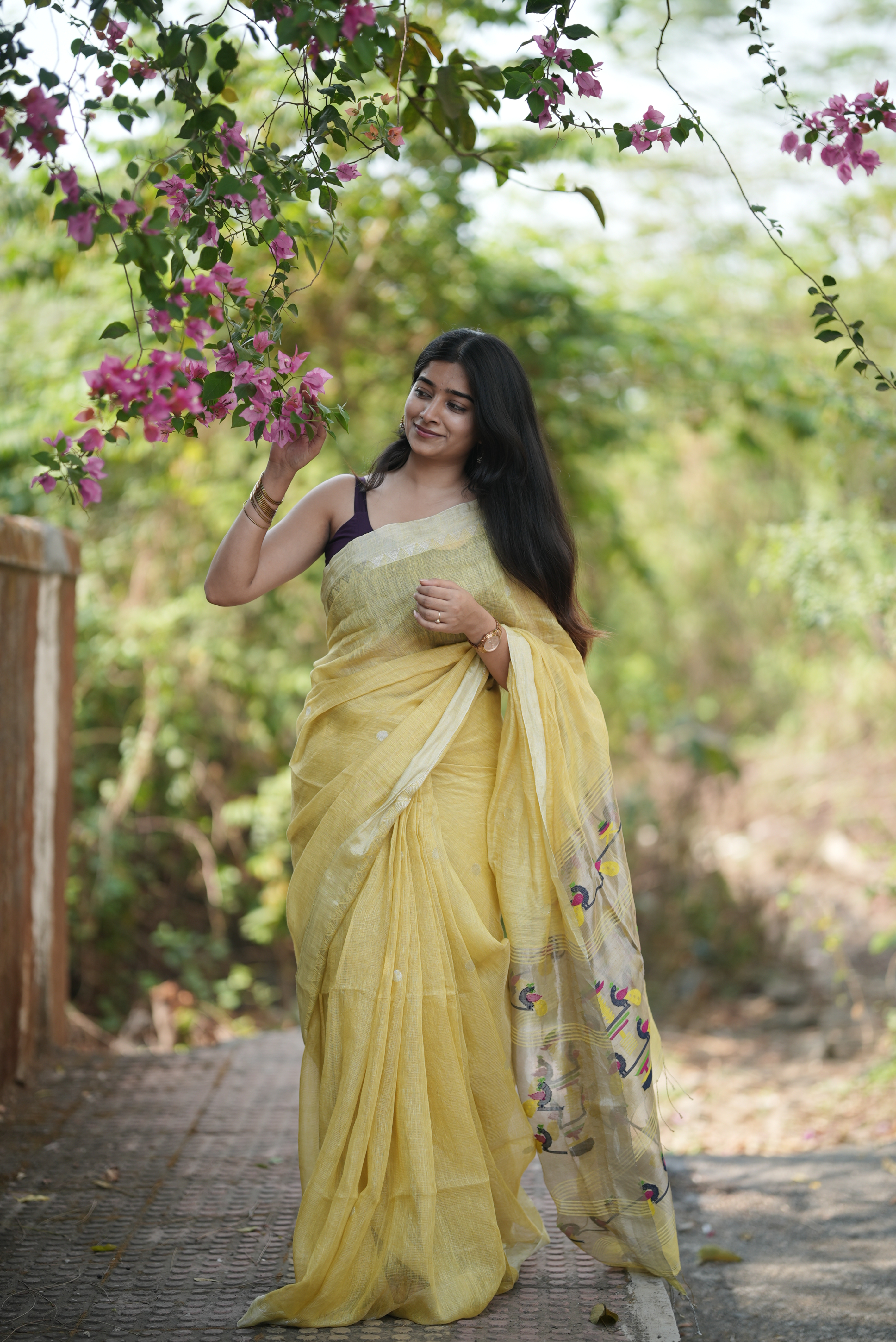 Lemon yellow silk linen Paithani featuring a classic temple border, elegant circular buttas, and a beautifully detailed peacock pallu