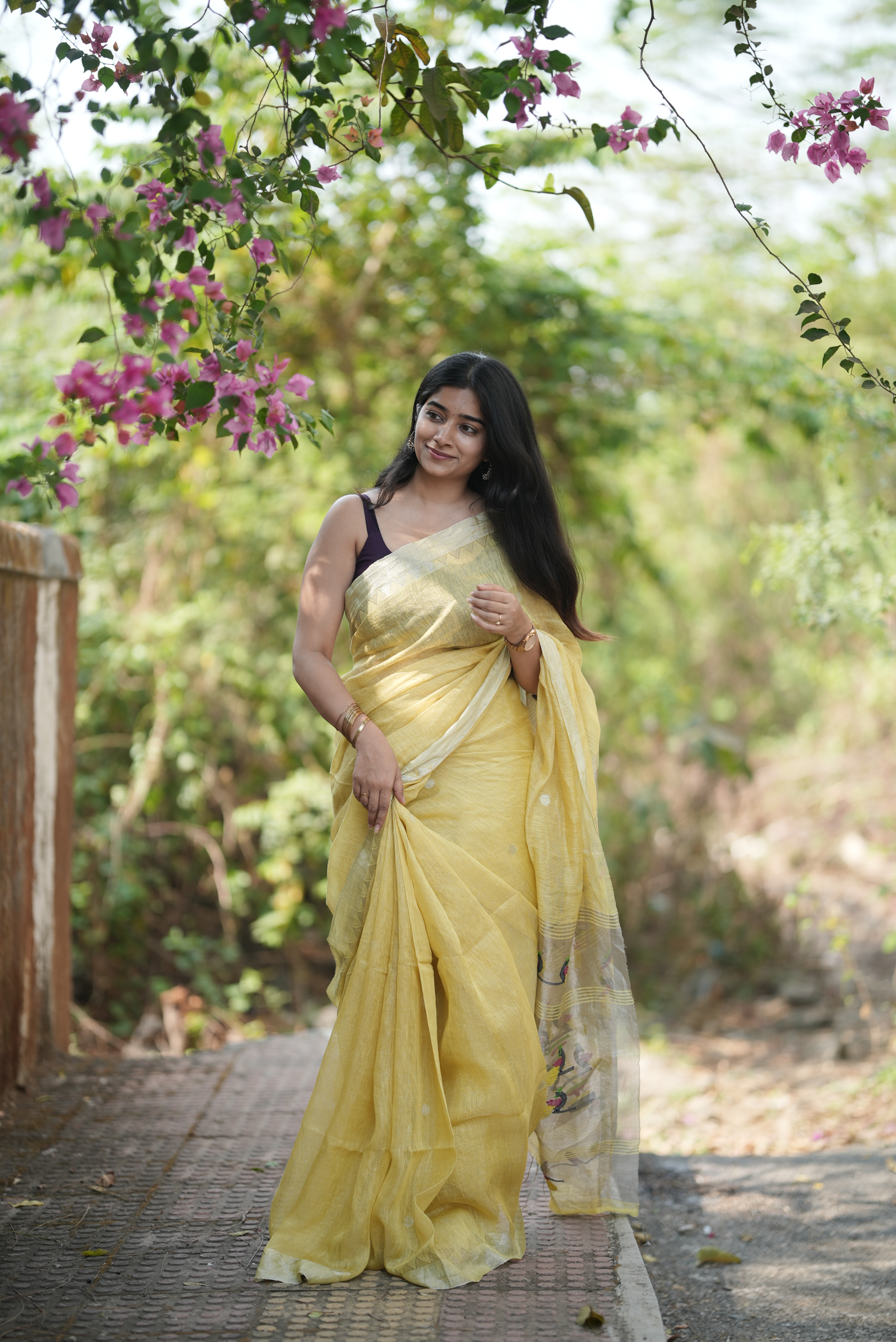 Lemon yellow silk linen Paithani featuring a classic temple border, elegant circular buttas, and a beautifully detailed peacock pallu
