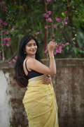 Lemon yellow silk linen Paithani featuring a classic temple border, elegant circular buttas, and a beautifully detailed peacock pallu