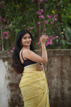 Lemon yellow silk linen Paithani featuring a classic temple border, elegant circular buttas, and a beautifully detailed peacock pallu