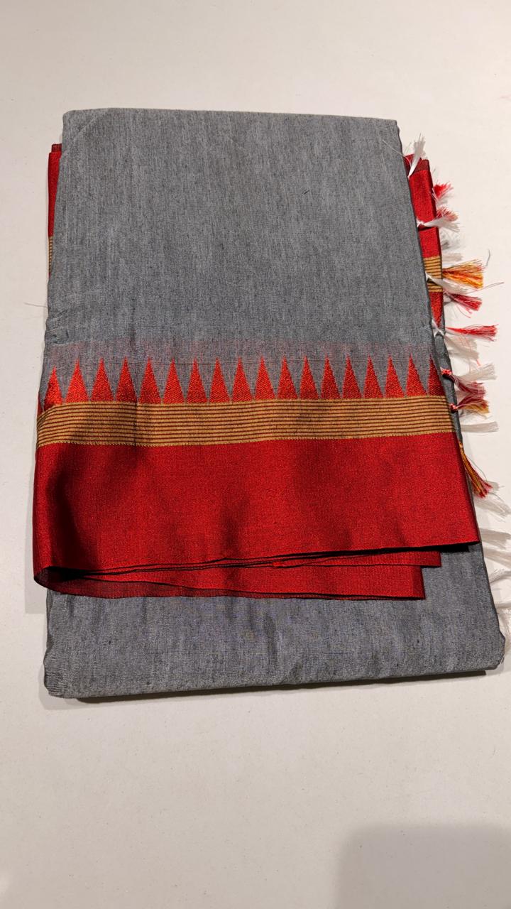 Grace meets everyday comfort with this elegant Cotton Temple Border Saree. Featuring a soothing  body paired with a rich  temple border accented with fine golden zari detailing.